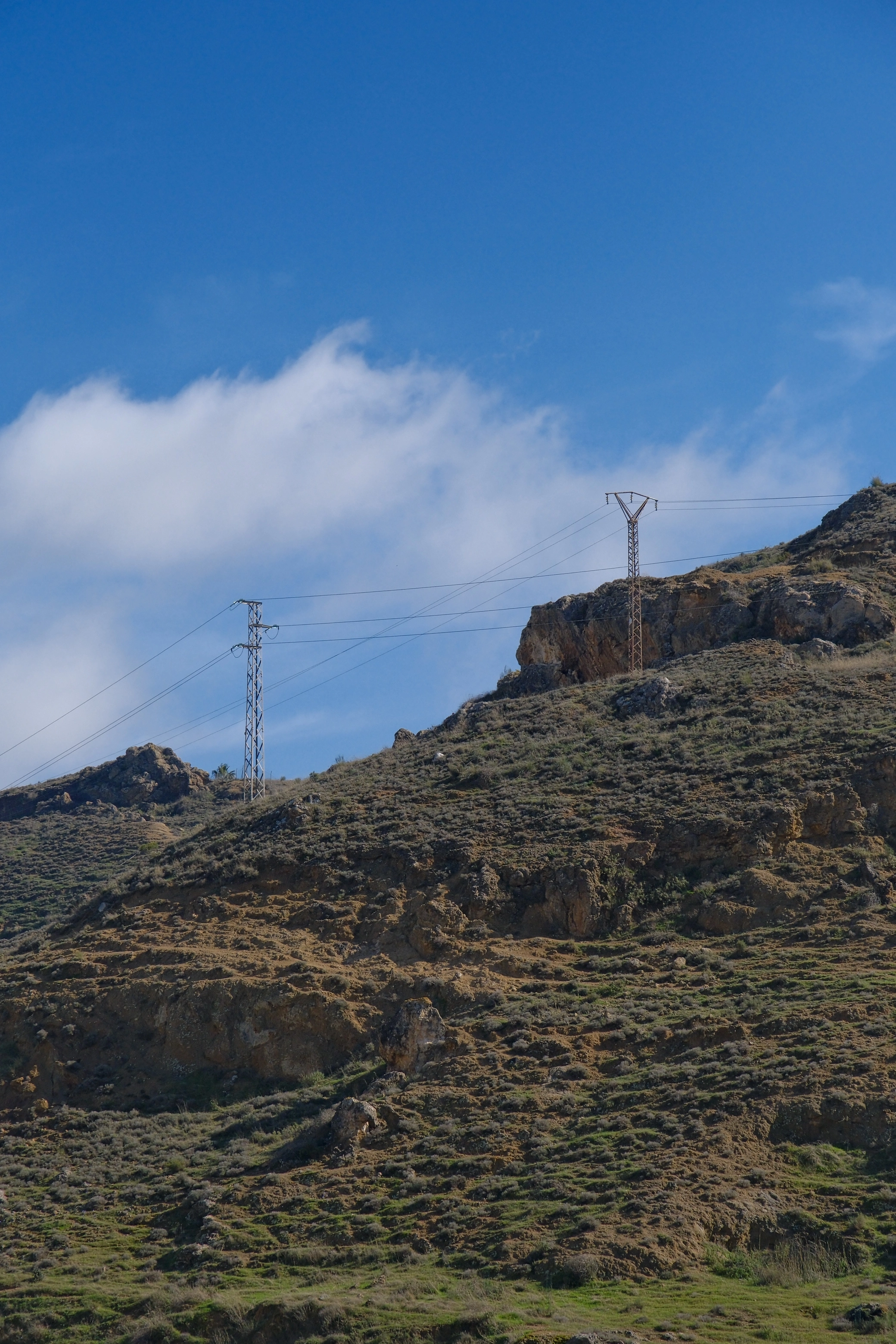 Encuadre vertical de paisaje que estudia terreno, luz y distancia.